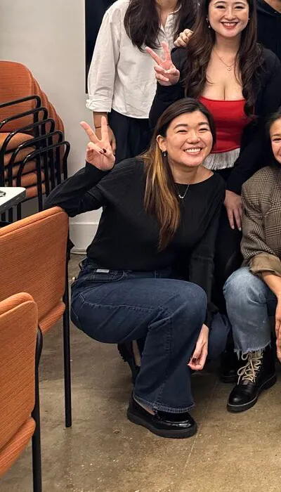 Ser En Low smiling with participants at an AI video event in New York
